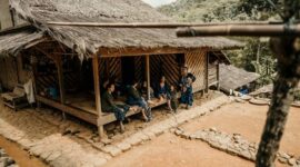 Warga masyarakat adat berjalan melintasi kawasan hutan ulayat yang terjaga kelestariannya di daerah Jawa Barat. Foto ini merekam keharmonisan hubungan antara manusia dan alam yang diwariskan secara turun-temurun.
