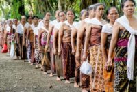 Anggota masyarakat adat berjalan menyusuri kawasan hutan lindung yang dijaga kelestariannya secara turun-temurun di wilayah pedalaman Nusantara. Foto ini merekam keharmonisan hubungan antara manusia dan alam yang tetap terjaga di tengah arus modernisasi.